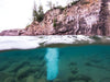 Split waterline view of Kasco Robust Aire diffuser operating beneath lake surface with visible bubble column