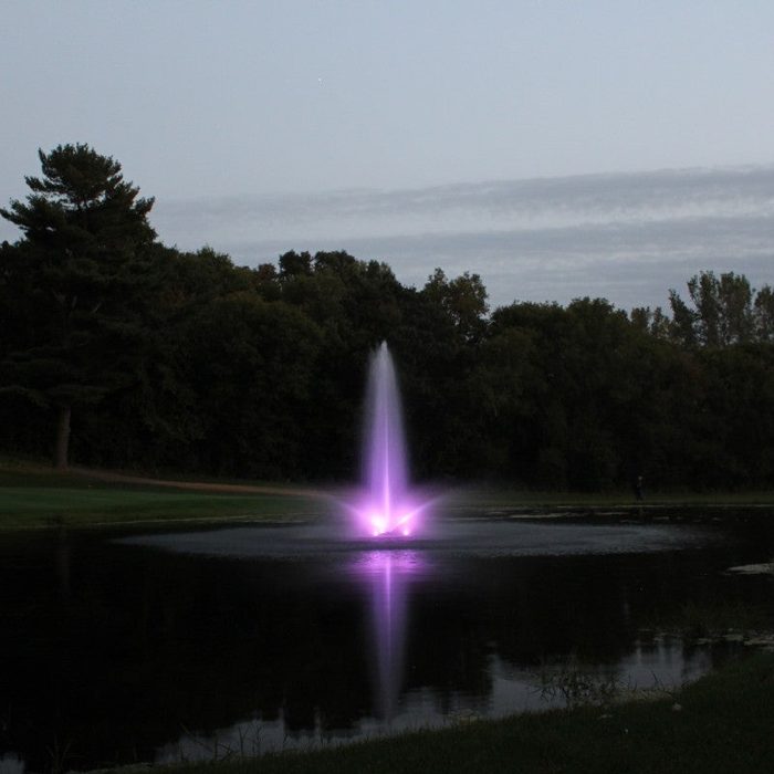 WaterGlow RGB LED illuminating a vertical pond fountain with purple light during dusk