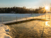 Winter dock with open water area around pier at sunrise demonstrating ice prevention using Kasco De-Icer